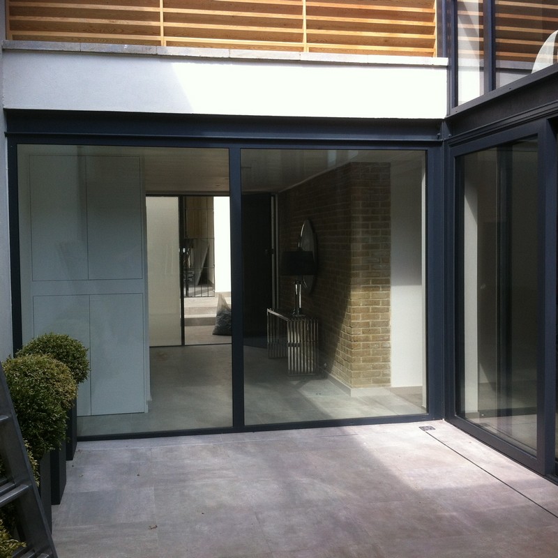 Floor-to-ceiling sliding doors opening to courtyard in Walthamstow