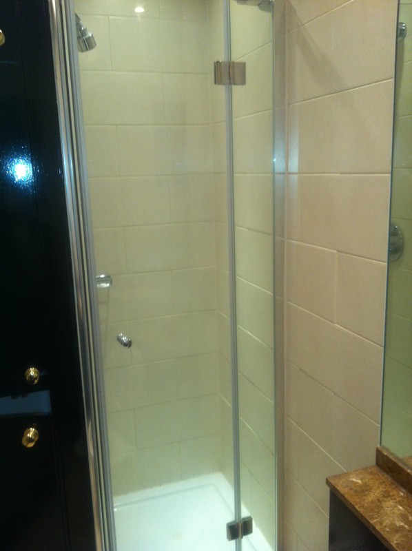 Frameless glass shower enclosure with chrome fittings in Walthamstow