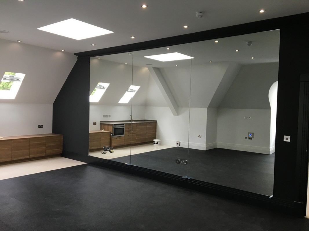 Frameless glass wall dividing loft conversion in Walthamstow