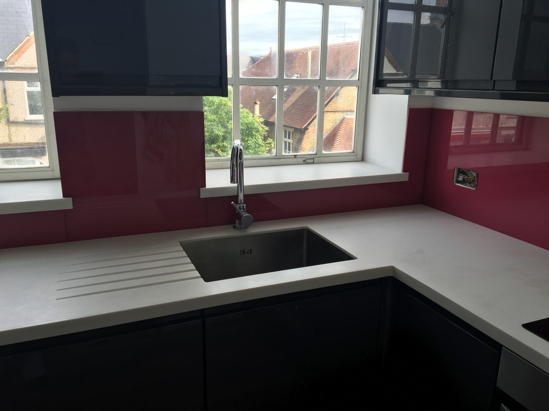 Deep plum coloured glass splashback in modern Walthamstow kitchen